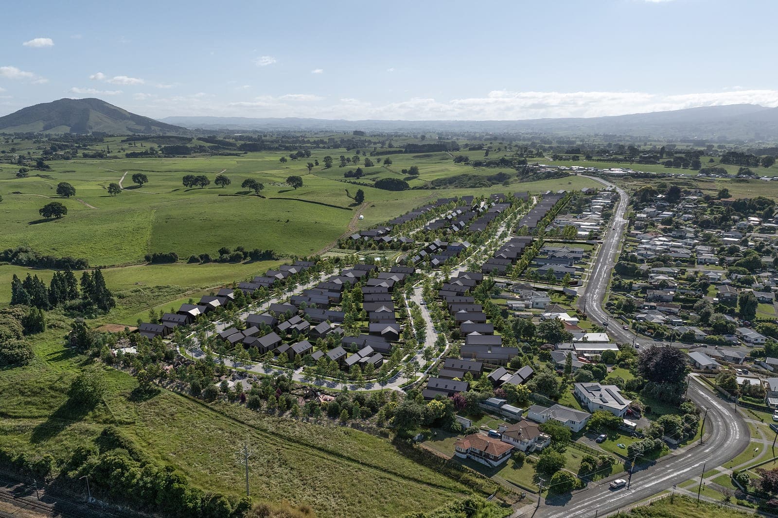 Tree-lined streets of homes at Parkview, looking across the neighbourhood to the Waikato countryside